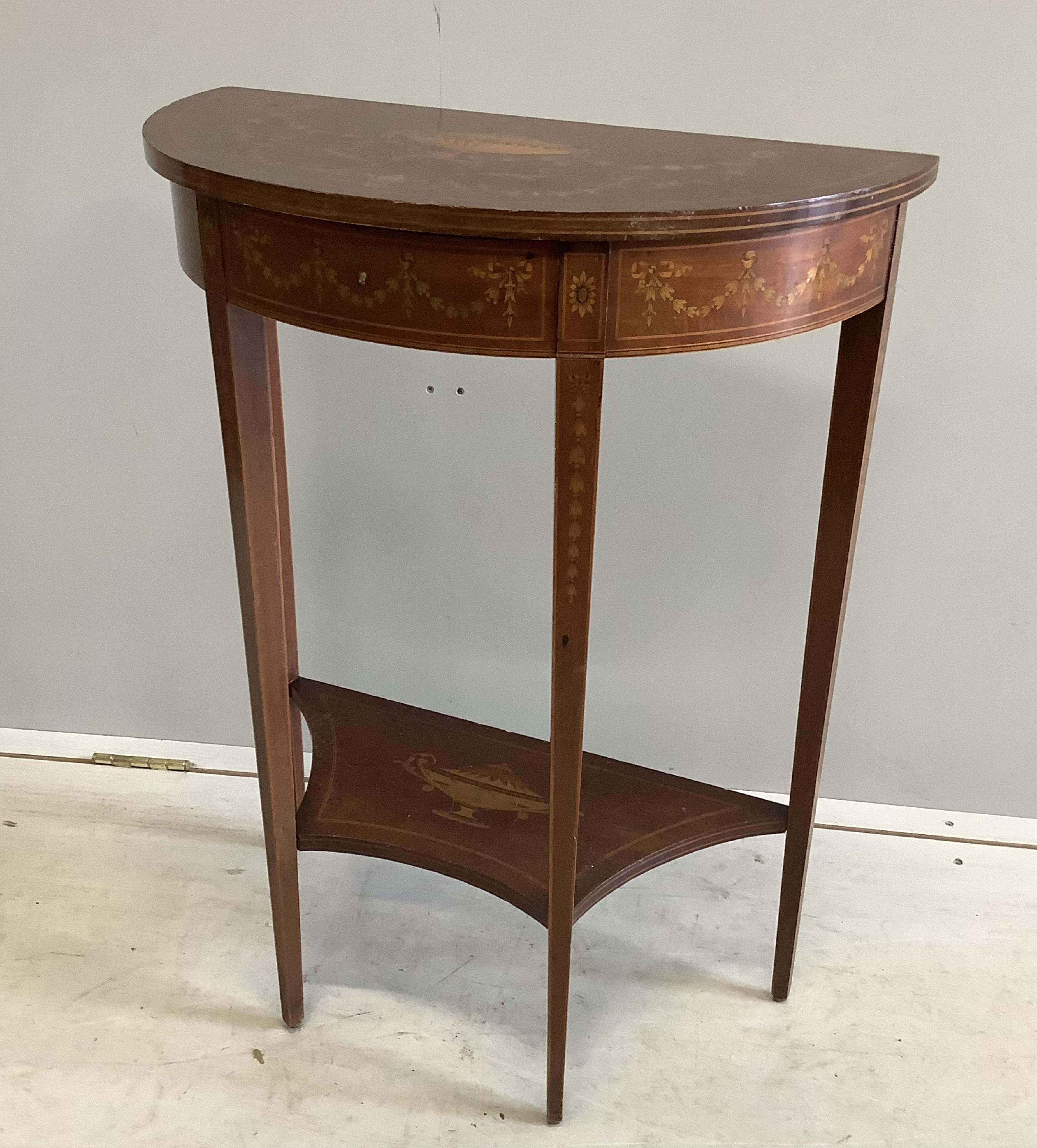 A Edwardian marquetry inlaid mahogany D shaped two tier side table in the manner of Edward & Roberts, width 57cm, depth 29cm, height 75cm. Condition - fair to good